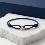 Navy cord bracelet with three interlocking rings