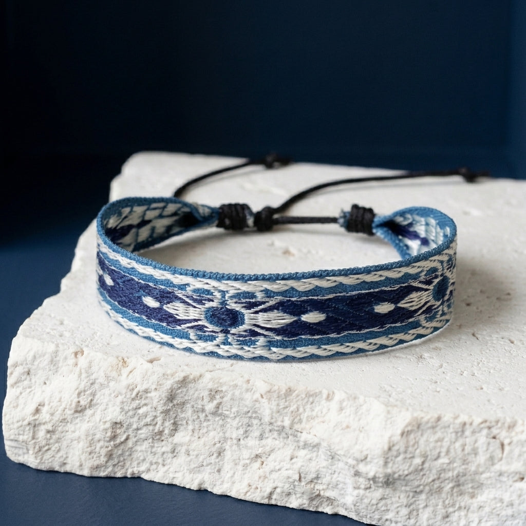 Wide woven blue and cream bracelet with adjustable cord