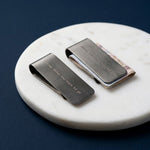 Brushed gunmetal money clip with engraved motto